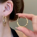 Elegant gold-tone oval hoop earrings featuring textured geometric facets and smooth finish - Faceted Patchwork Oval Hoop Earrings (107#) / Gold