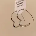 Close-up of minimalist S925 silver heart-shaped hoop earrings with product tag - Style (7#) / Silver