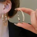 Silver textured hoop earrings featuring a minimalist oval design with elegant ribbing - Horizontal Grooved Oval Hoop Earrings (115#) / Silver