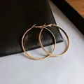 Minimalist golden elliptical hoop earrings with a textured finish for a chic look - Frosted Hammered Oval Hoop Earrings (116#) / Diameter 50mm / Gold