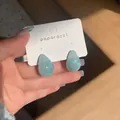 Close-up of elegant light blue resin waterdrop earrings with marble swirl pattern effect - Water Drop Stud Earrings (HE30676---1) / Blue