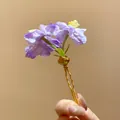 Close-up detail of an elegant purple fabric flower hairpin with a golden wavy hair fork - Hair Stick Gold-Purple / Purple