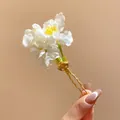 Detailed macro shot of a white fabric flower hair pin with a golden metal fork - Hair Stick Gold-White / White