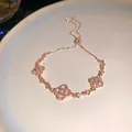 Elegante bracciale regolabile in oro rosa con ciondoli a quadrifoglio e zirconi scintillanti - Bracciale Scorrevole Petalo Cavo (64#) / Oro rosa
