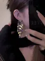 Detailed close-up showing shimmering silver sequin fringe drop earrings on a model - Silver Pin Tassel Style / Silver
