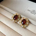Vintage oval jewelry details featuring red crystal and white enamel flowers, gold tone. - Stud Earrings / Gold-Red