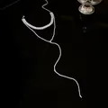 Detailed view of elegant sparkling rhinestone tassel necklace with Y-shaped drop design - Silver
