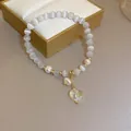 Elegant white cat eye bead bracelet featuring pearls and a sparkling heart pendant. - Rhinestone Pearl Cat's Eye Heart Style