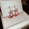 Macro view of elegant zircon flower earrings with pink teardrop crystals in jewelry box - Hook Style / Gold-Pink
