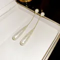Elegant French vintage gold chain earrings with long teardrop pearls for women - Gold And White