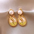Close-up of elegant French vintage drop earrings with pearls and rose enamel pendant. - Relief Rose Style (12#) / Pearl Painted