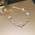 Close-up of gold-plated bracelet featuring zircon flower motifs and adjustable chain. - Bracelet-Gold (Real Gold Plating)