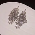 Close-up detail of silver snowflake tassel earrings with brilliant rhinestone inlay - Layered Snowflake Tassel Ear Hooks (17#)