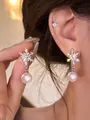 Close-up view of silver snowflake stud earrings with elegant white pearl drops - Snowflake Pearl Ear Clips (4#)