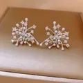 Macro detail of snowflake stud earrings featuring white pearls and sparkling rhinestones. - Silver Post Radiating Snowflake Studs (25#)