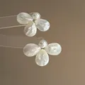 Elegant silver needle mother-of-pearl flower stud earrings featuring a white pearl center - White