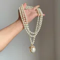 Dettaglio di collana di perle multi-filo in stile vintage francese con pendente strass - Bianco