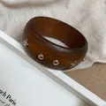 Detailed macro view of a vintage brown resin bangle featuring silver star and metal studs - 18# Bangle (18#) / Coffee/Silver