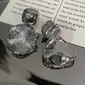 Detailed macro view of silver geometric stud earrings with brushed and mirror finishes - Irregular Brushed Hammered Geometric Jewelry (24#) / Silver