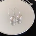 Close-up detail of brushed silver metal spherical earrings with elegant curved hooks. - Metal Brushed Spherical Arc Ear Hook (25#) / Silver