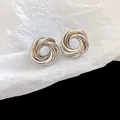 Detailed close-up view of silver-colored interlocking metallic stud earrings with a woven design - Intertwined Ring Geometric Silver Post Stud Earrings (29#) / Silver
