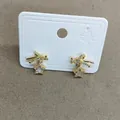 Exquisite gold bow and star stud earrings with sparkling zircons on a white display card - Silver Earring Post Style / Gold