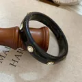Bracciale rigido vintage in resina nera decorato con inserti in pietra di cristallo - Nero