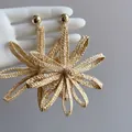 Close-up of woven straw flower earrings with golden studs in bohemian vacation style. - 10# Silver Earring Post - Brown