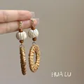 Close-up of bohemian woven rattan hoop earrings with wood beads and textured ball. - 11# Steel Needle - Coffee - Round