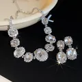 Macro view of French luxury oval crystal necklace and earring set with sparkling stones - Necklace and Earring Set / Silver