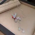 Detail view of silver rhinestone reindeer necklace with snowflakes and red nose pendant - Necklace (Red Reindeer)