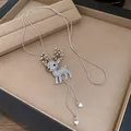 Close-up of sparkling rhinestone reindeer pendant on silver snake chain necklace - Necklace (Brown Reindeer)