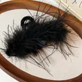 Detailed view of an elegant black feather hair claw clip with soft fluffy textures - Shark Clip
