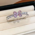 Detailed macro view of elegant silver-toned double-layer zircon butterfly open bangle - Bangle-Pink Zirconia / Silver