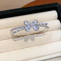 Detailed view of an elegant silver-colored double-layer butterfly bangle with zircons. - Bangle-White Zirconia / Silver