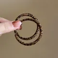 Close-up detail of stylish leopard print leather hoop earrings for a minimalist look - Round Style (34#) / Silver Needle / Brown