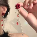 Detailed view of red rose dangle earrings with pearls and crystal drops for a romantic look - Tassel Earrings / Red