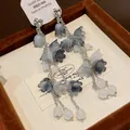Vue détaillée de boucles d'oreilles fleurs bleu dégradé avec perles blanches et chaîne argent. - Boucles d'Oreilles Gland Fleur (HE19046) / Gris
