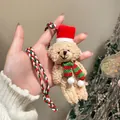 Detailed close-up of a festive plush teddy bear pendant with a Christmas scarf and hat. - Christmas Bear (Red-White)
