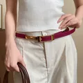 Close-up of a slim magenta leather belt with a gold buckle on a model's waist. - Thin Pin Buckle Style (HN10223)