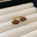 Close-up of French vintage brown enamel oval earrings with a glossy gold-tone finish - Oval Earrings (HE5503)