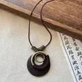 Vintage ethnic style long necklace with dark wood and brass circular pendants. - Coffee-Round