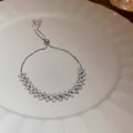 Detail view of a sparkling cubic zirconia adjustable bracelet on a white plate - Geometric Style (33#)