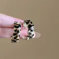 Detail shot of vintage leopard print hoop earrings with wavy edges and glossy finish. - Wavy C-Shape (3#)