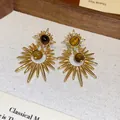 Macro detail of vintage sunburst earrings featuring tiger eye stones and zircons. - Sunburst Star Style (WE5749) / Gold with Coffee Tiger Eye (Silver Pin)