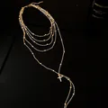 Detailed view of a gold multi-layer necklace featuring a shimmering zircon cross pendant. - Necklace / Gold