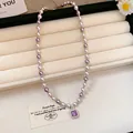 Detailed view of a French pearl necklace with a square purple zircon pendant centerpiece. - Choker Necklace