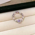 French style pearl ring with a square purple zircon centerpiece in a jewelry box. - Ring
