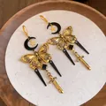 Detailed view of vintage gothic tassel earrings featuring moon, butterfly and sword charms - Ear Buckle / Gold-Black