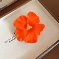 Small orange satin flower hair clip featuring a minimalist and elegant floral design - Bright Orange - Duckbill Clip